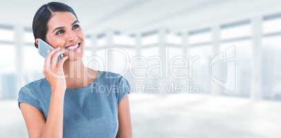 Composite image of beautiful businesswoman using mobile phone