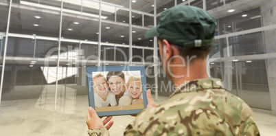 Composite image of soldier using tablet pc