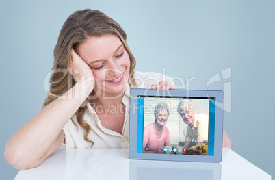 Composite image of woman showing tablet pc