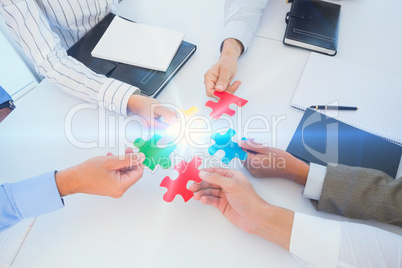 Business colleagues holding piece of puzzle