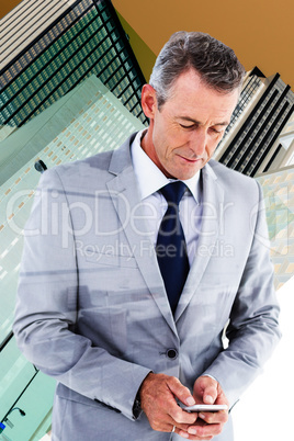 Composite image of businessman sending text