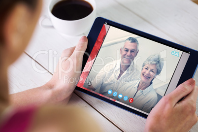 Composite image of woman using tablet pc