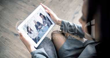 Composite image of businesswoman using tablet