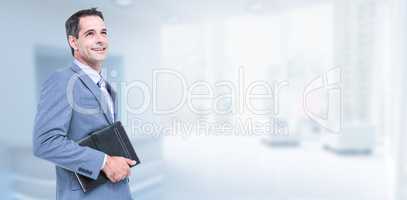 Composite image of smiling businessman holding diary