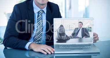 Composite image of portrait of smiling businessman showing lapto
