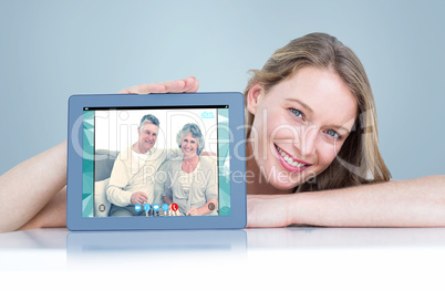 Composite image of woman showing tablet pc Composite image of woman showing tablet pc