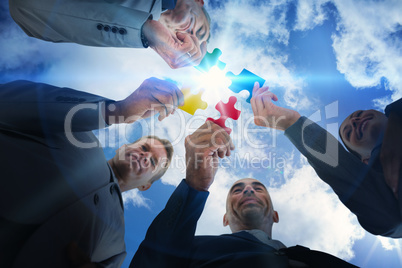 Business colleagues holding piece of puzzle