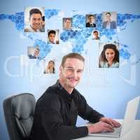 Composite image of smiling businessman using laptop at desk