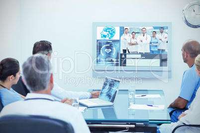 Composite image of team of doctors having a meeting