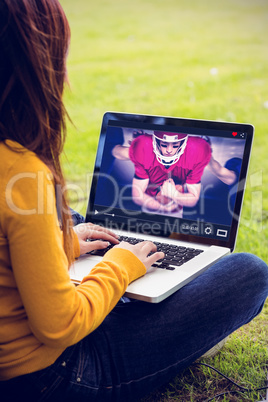 Composite image of woman using laptop in park