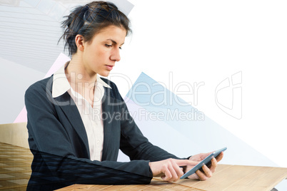 Composite image of businesswoman using tablet at desk