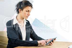 Composite image of businesswoman using tablet at desk