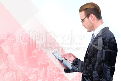 Composite image of businessman in reading glasses using his tabl