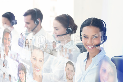 Composite image of business people with headsets using computers