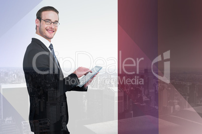 Composite image of happy businessman using his tablet pc