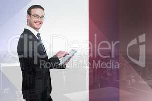 Composite image of happy businessman using his tablet pc