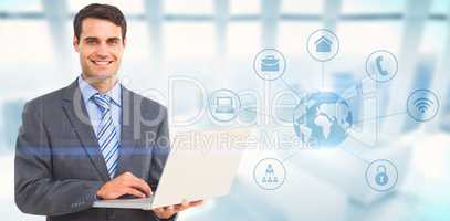 Composite image of portrait of smiling businessman using laptop