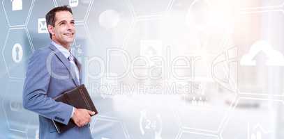 Composite image of smiling businessman holding diary