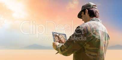 Composite image of army officer using tablet