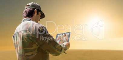 Composite image of army officer using tablet