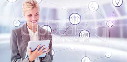 Composite image of smiling buisnesswoman using digital tablet