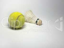 tennis ball and badminton shuttlecock on white