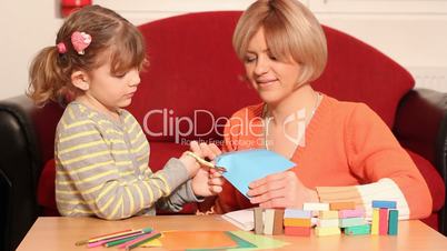 little girl cutting with scissors