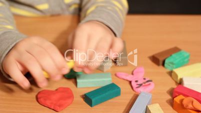 little girl play with plasticine