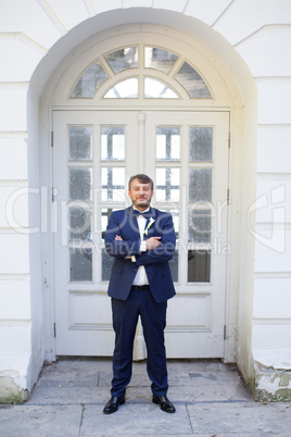 Unshaven groom in a blue suit