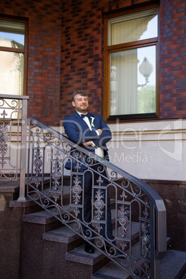 Unshaven groom in a blue suit