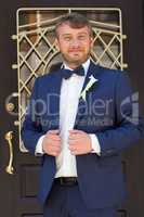 Unshaven groom in a blue suit