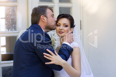 Groom in white shirt kissing bride hand. Very gentle photo