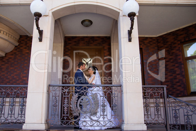 Wedding newlyweds kiss on a sunny day