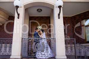 Wedding newlyweds kiss on a sunny day