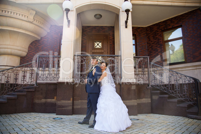 Wedding newlyweds kiss on a sunny day