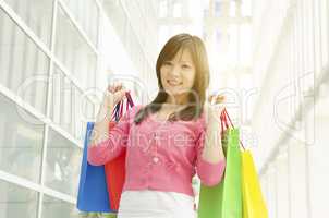 Asian girl holding shopping bags