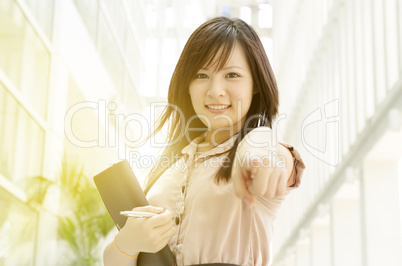 Young Asian female executive pointing at you
