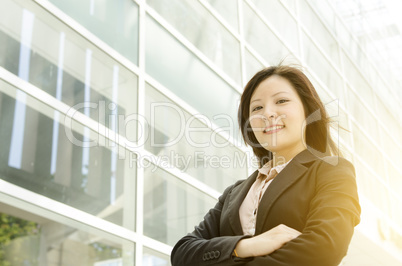 Young Asian business woman arms crossed