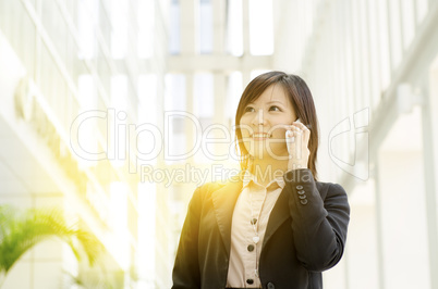 Young Asian business woman calling on phone