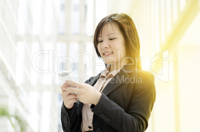 Young Asian business woman using smartphone