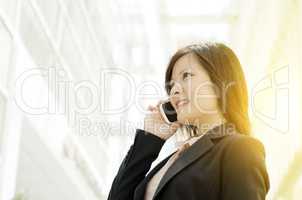 Young Asian business woman talking on mobile phone