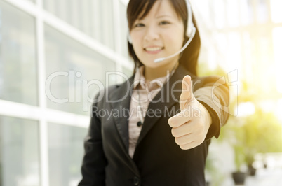 Asian female receptionist thumb up