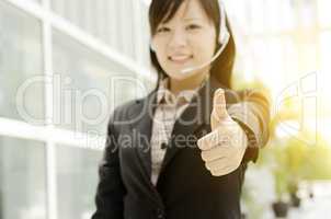 Asian female receptionist thumb up