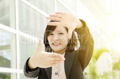 Asian business woman making hand frame