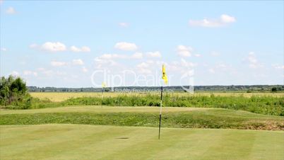 golf course with two yellow flags