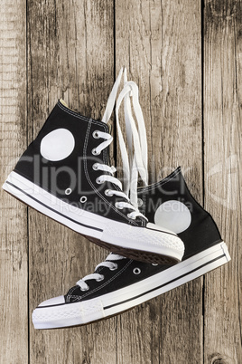 Black sneakers on wooden