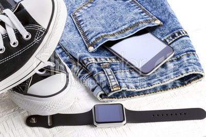 Smartphone, smartwatch and jeans