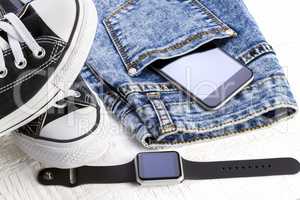 Smartphone, smartwatch and jeans
