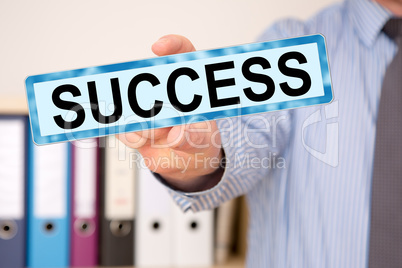 Businessman holding sign with inscription, SUCCESS