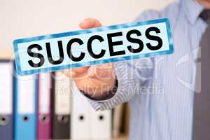 Businessman holding sign with inscription, SUCCESS